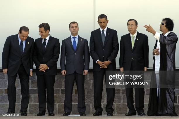 President Barack Obama stands with United Nations Secretary General Ban Ki-moon , Libyan President Moammar Kadafi , Russian President Dmitry Medvedev...