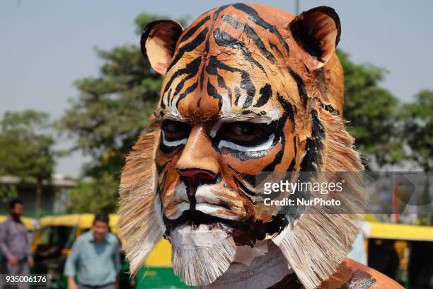 People for the Ethical Treatment of Animals member body-painted as a tiger stands to promote vegan eating ahead of International Day of Forests in...