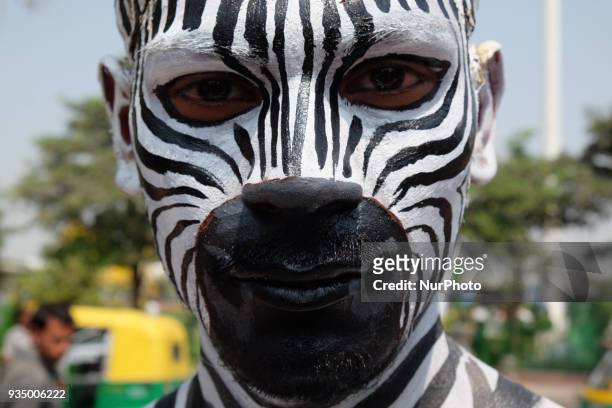 People for the Ethical Treatment of Animals member body-painted as a zebra promotes vegan eating ahead of International Day of Forests in New Delhi...