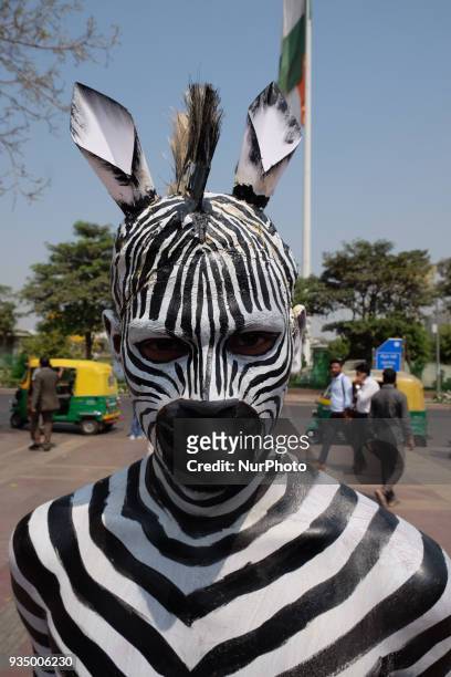 People for the Ethical Treatment of Animals member body-painted as a zebra promotes vegan eating ahead of International Day of Forests in New Delhi...