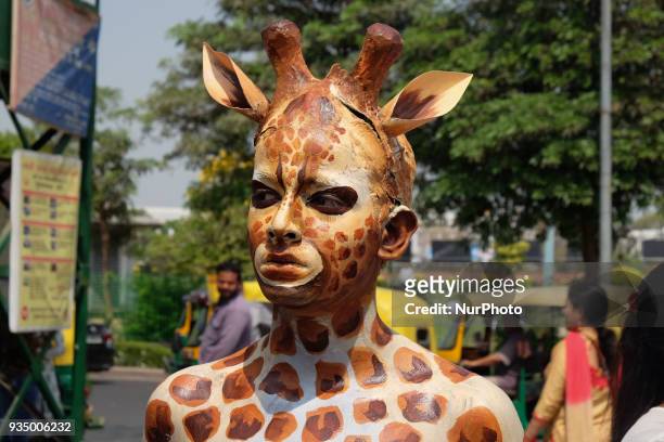 People for the Ethical Treatment of Animals member body-painted as a giraffe stands to promote vegan eating ahead of International Day of Forests in...