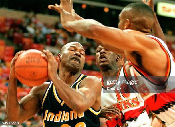 Indiana Pacers Ricky Pierce is swarmed by Atlanta Hawks Mookie Blaylock and Steve Smith during the first quarter 17 January in Atlanta, Ga. Pierce...