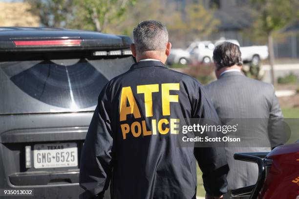 Agents continue their investigation at a FedEx facility following an explosion on March 20, 2018 in Schertz, Texas. A package exploded while being...