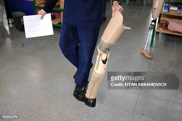Man carries a prosthesis at the Colombian Centre for Integrated Rehabilitacion in Bogota on November 24, 2009. AFP PHOTO/Eitan Abramovich