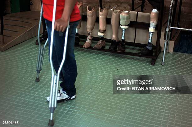 Humberto Jesus Guevara Trejos, a victim of a landmine explosion, stands next to a set of prosthesis at the Colombian Centre for Integrated...