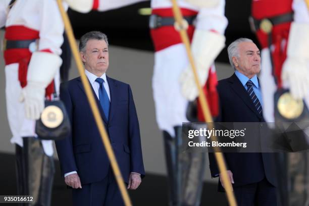 Michel Temer, Brazil's president, right, and Juan Manuel Santos, Colombia's president, stand during the national anthem at an event in Brasilia,...