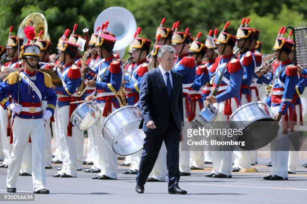 Juan Manuel Santos, Colombia's president, center, arrives to an event with Michel Temer, Brazil's president, not pictured, in Brasilia, Brazil, on...