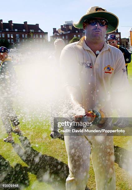 Leg spinner Shane Warne sprays the photographers with champagne as Australia celebrate at the end of the fifth day of the 5th Test match between...