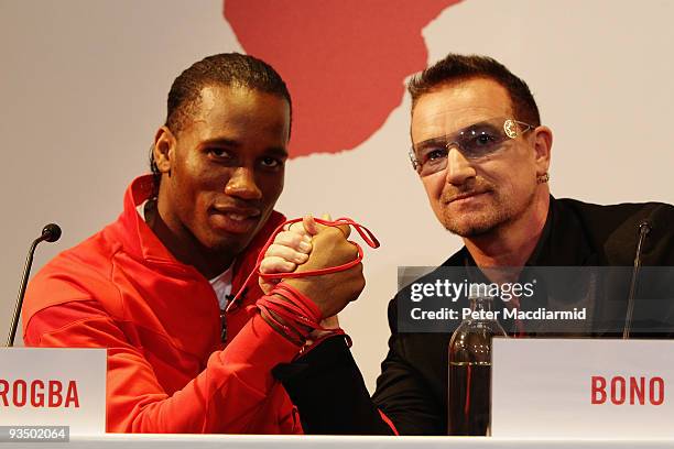 Footballer Didier Drogba and musician Bono attends the NIKE & Charity Announcement at NikeTown on November 30, 2009 in London, England. On the day...