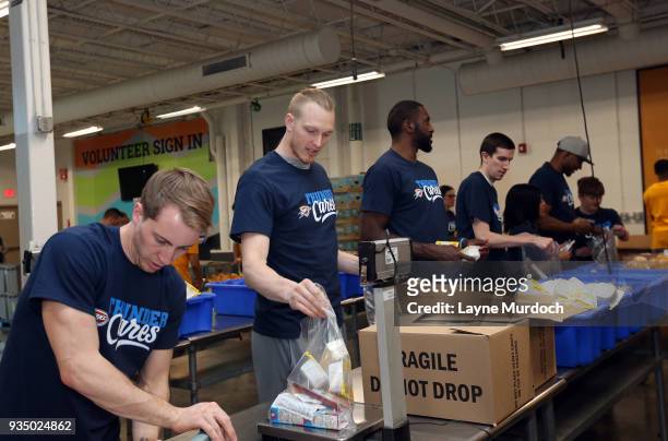 Oklahoma City Thunder players Kyle Singler and Patrick Patterson volunteer with Thunder players, coaches and staff on March 15, 2018 at the Regional...