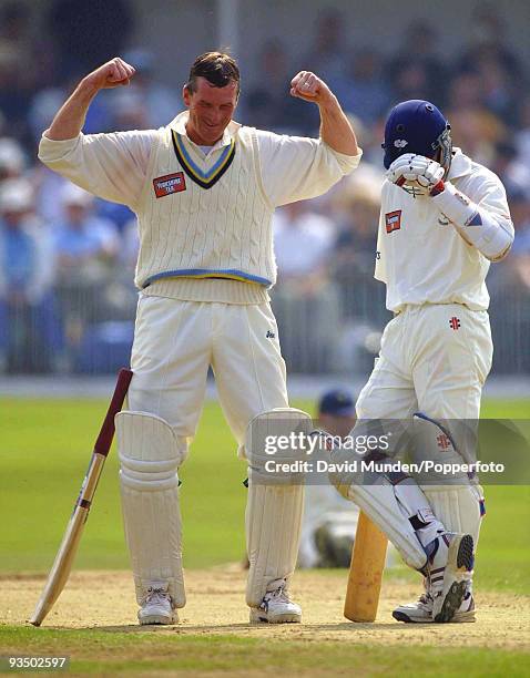 Yorkshire captain David Byas celebrates after reaching his century with batting partner Richard Blakey on the third day of the CricInfo County...