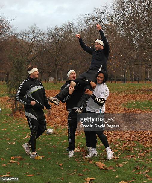 Wyatt Crockett, Ben Smith and Rodney So'oialo hold Brendon Leonard aloft during the All Blacks recovery games session held in Hyde Park on November...