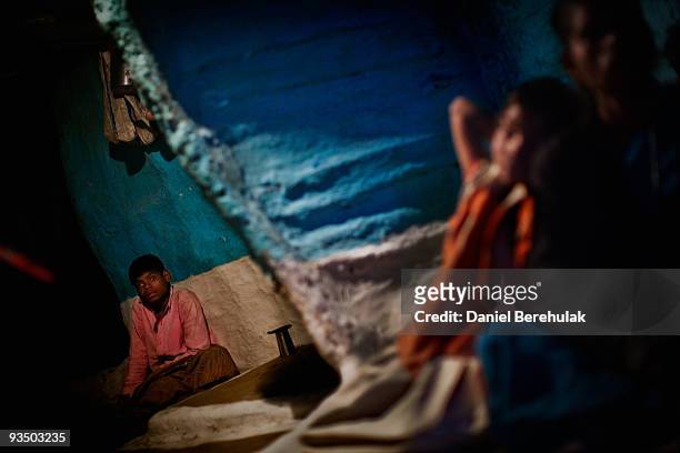 Fifteen year old Sachin Kumar watches television in a slum near the site of the deserted Union Carbide factory on November 29, 2009 in Bhopal, India....