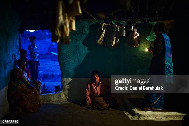 Fifteen year old Sachin Kumar looks on as he sits waiting for his dinner at his home in a slum near the site of the deserted Union Carbide factory on...
