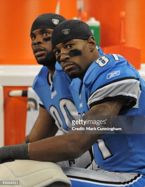 Bryant Johnson and Calvin Johnson of the Detroit Lions look on from the sidelines during the game against the Green Bay Packers at Ford Field on...