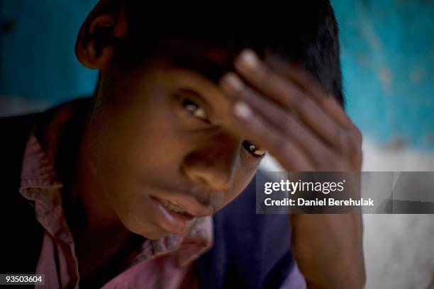 Fifteen year old Sachin Kumar rests at his home located in a slum near the site of the deserted Union Carbide factory on November 30, 2009 in Bhopal,...