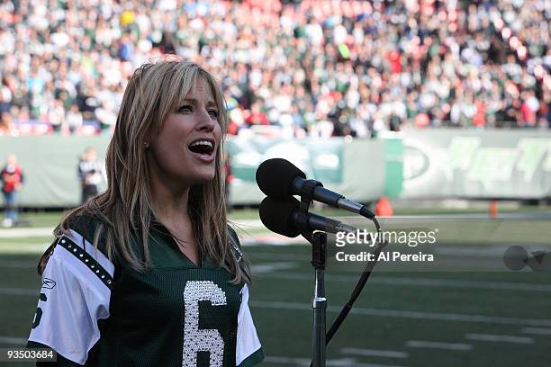 Singer and former WWE RAW personality Lilian Garcia performs the national anthem during the Carolina Panthers football game against the New York Jets...