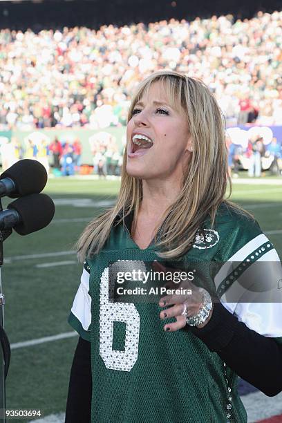 Singer and former WWE RAW personality Lilian Garcia performs the national anthem during the Carolina Panthers football game against the New York Jets...