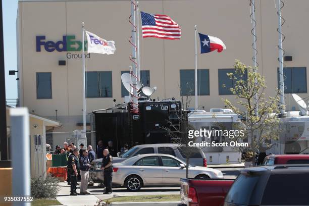 And local police investigate an explosion at a FedEx facility on March 20, 2018 in Schertz, Texas. A package exploded while being transported on a...