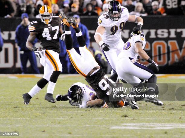 Wide receiver Josh Cribbs of the Cleveland Browns lands on his head after being tackled by defensive back Ed Reed of the Baltimore Ravens during a...