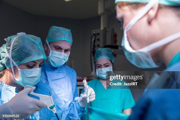 artsen uitvoeren van chirurgie in het theater - laparoscopy stockfoto's en -beelden