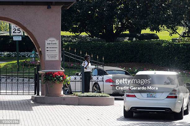 Security guard watches from the gate of the Isleworth community, which is home to Tiger Woods, on November 30, 2009 in Windermere, Florida. Tiger...
