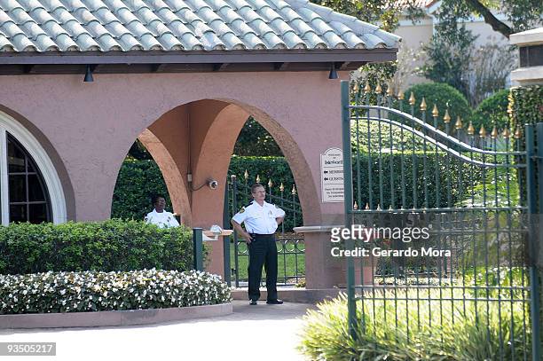 Security guards watch from the gate of the Isleworth community, which is home to Tiger Woods, on November 30, 2009 in Windermere, Florida. Tiger...