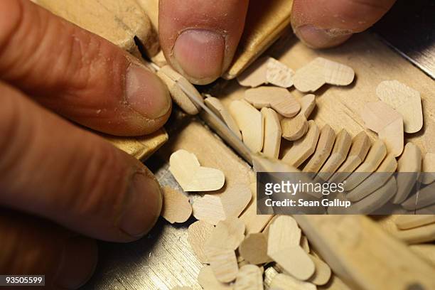 An artisan prepares miniature, wooden left and right arms for Christmas figurines at the Richard Glaesser GmbH wooden toy manufactory on November 30,...