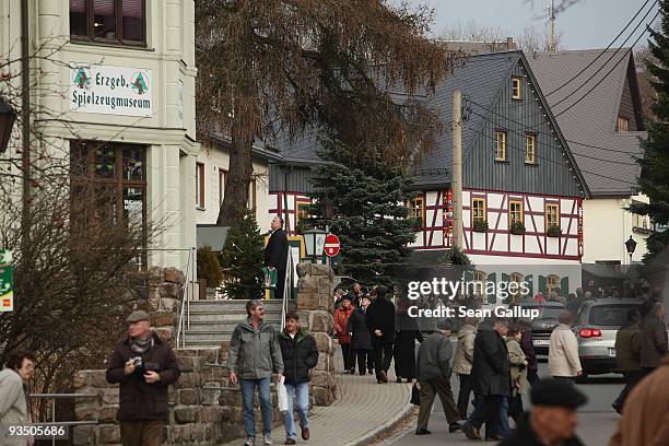 Visitors walk down the main street of shops selling hand-made, wooden Christmas ornaments and figurines on November 30, 2009 in Seiffen, Germany....