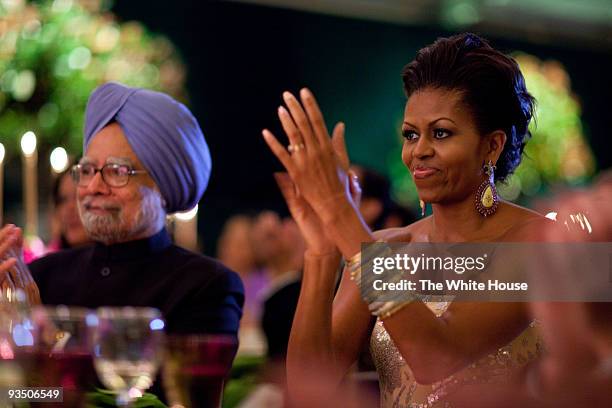 In this handout provided by the White House, first lady Michelle Obama claps during the entertainment portion of the State Dinner for Prime Minister...