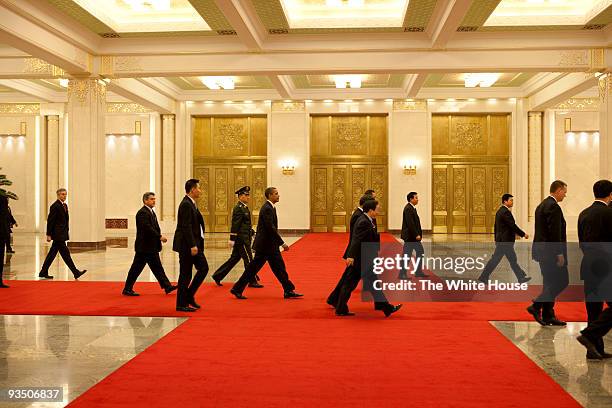 In this handout provided by the White House, President Barack Obama and others walk through the Great Hall of the People after attending a state...