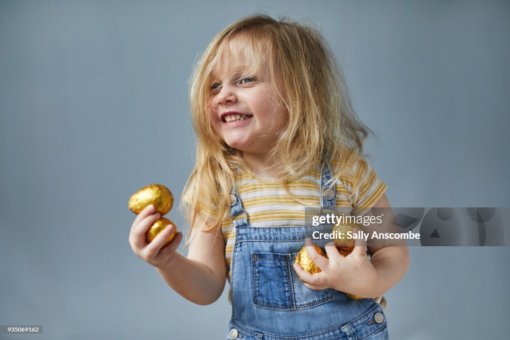 Happy child holding Easter Eggs