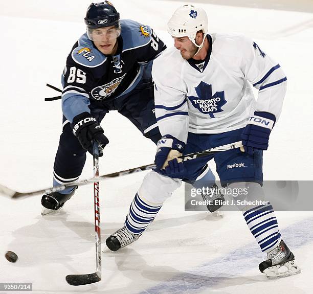 Rostislav Olesz of the Florida Panthers tangles with Ian White of the Toronto Maple Leafs at the BankAtlantic Center on November 27, 2009 in Sunrise,...