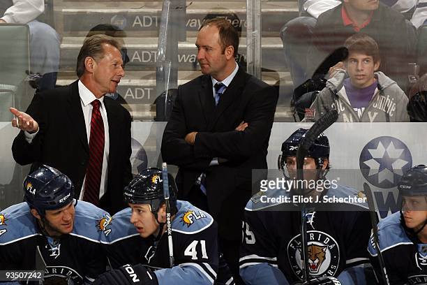 Head Coach Peter DeBoer of the Florida Panthers chats with Assistant Coach Mike Kitchen during the action against the Toronto Maple Leafs at the...