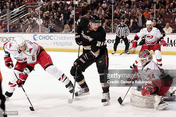 Manny Legace of the Carolina Hurricanes defends the crease against Evgeny Artyukhin of the Anaheim Ducks during the game on November 25, 2009 at...