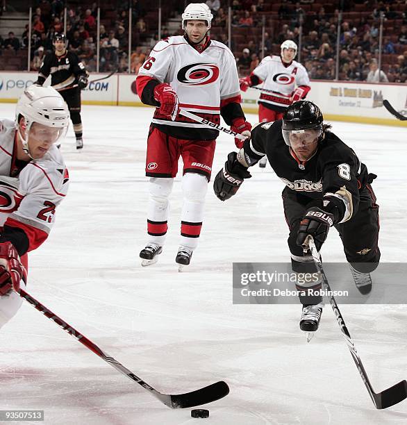 Joni Pitkanen of the Carolina Hurricanes controls the puck against Teemu Selanne of the Anaheim Ducks during the game on November 25, 2009 at Honda...