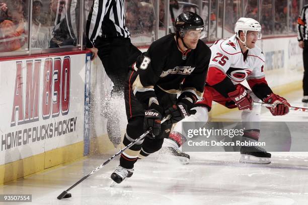 Joni Pitkanen of the Carolina Hurricanes defends against Teemu Selanne of the Anaheim Ducks during the game on November 25, 2009 at Honda Center in...