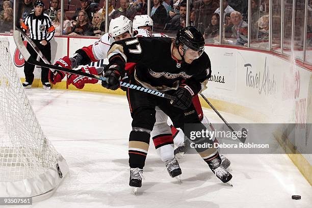 Petteri Nokelainen of the Anaheim Ducks controls the puck alongside the boards during the game against the Carolina Hurricanes on November 25, 2009...