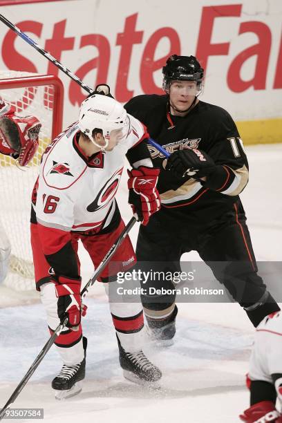 Brandon Sutter of the Carolina Hurricanes defends outside the crease against Corey Perry of the Anaheim Ducks during the game on November 25, 2009 at...