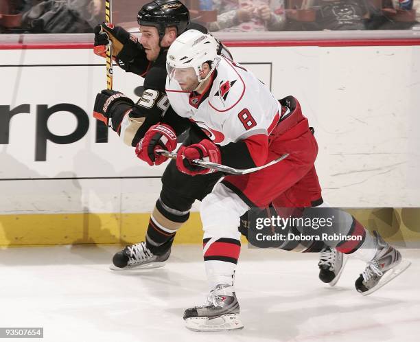 Matt Cullenn of the Carolina Hurricanes races alongside the boards against James Wisniewski of the Anaheim Ducks during the game on November 25, 2009...