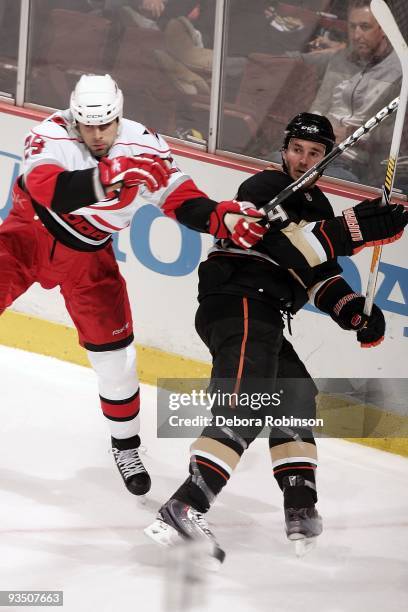Tom Kostopoulos of the Carolina Hurricanes collides with James Wisniewski of the Anaheim Ducks during the game on November 25, 2009 at Honda Center...