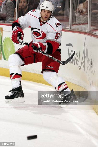 Tim Gleason of the Carolina Hurricanes passes the puck alongside the boards against the Anaheim Ducks during the game on November 25, 2009 at Honda...