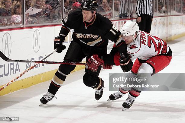 Joni Pitkanen of the Carolina Hurricanes battles for position against Ryan Whitney of the Anaheim Ducks during the game on November 25, 2009 at Honda...