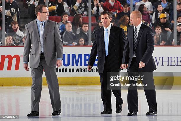 Head coach Dan Bylsma, left, and assistant coaches Tony Granato and Mike Yeo, all of the Pittsburgh Penguins, walk to the bench before the game...