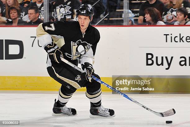 Defenseman Mark Eaton of the Pittsburgh Penguins skates with the puck against the Montreal Canadiens on November 25, 2009 at Mellon Arena in...