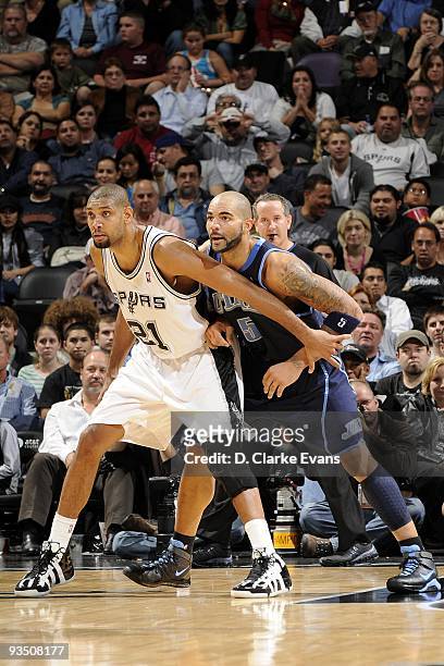 Tim Duncan of the San Antonio Spurs battles for position against Carlos Boozer of the Utah Jazz during the game at AT&T Center on November 19, 2009...