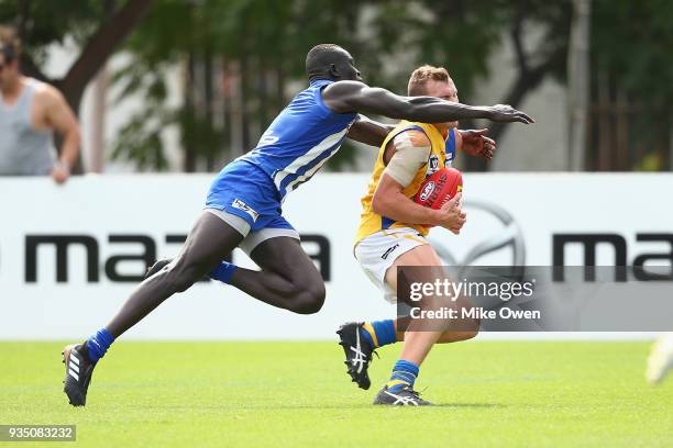 Majak Daw of the Kangaroos tackles Hayden Walters of Williamstown during the VFL practice match between North Melbourne and Williamstown at Arden...