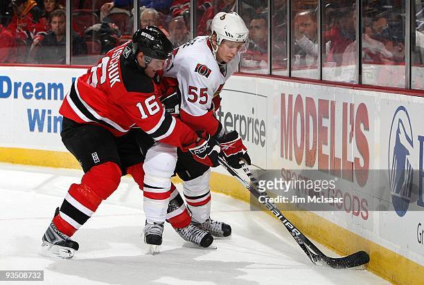 Brian Lee of the Ottawa Senators skates against Matt Halischuk of the New Jersey Devils at the Prudential Center on November 25, 2009 in Newark, New...