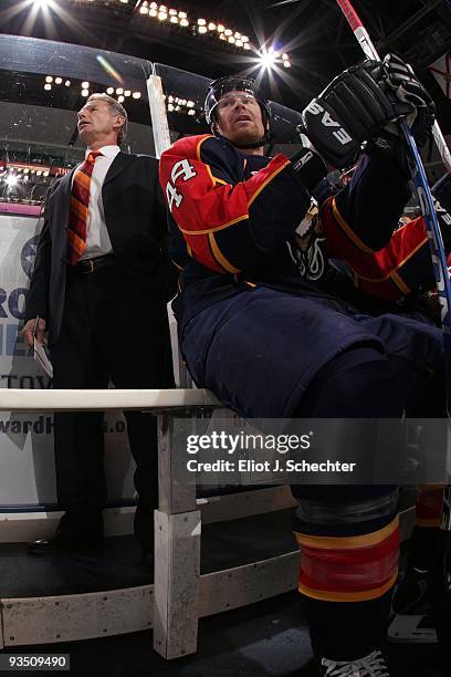 Jordan Leopold of the Florida Panthers sits on the bench and watches the action with Assistant Coach Mike Kitchen against the New York Rangers at the...