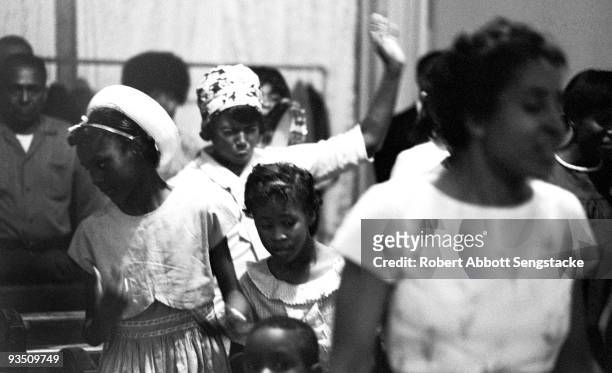 View of church goers dancing and singing while participating in a religious service at the Temple Apostolic Church, a storefront church in Chicago,...